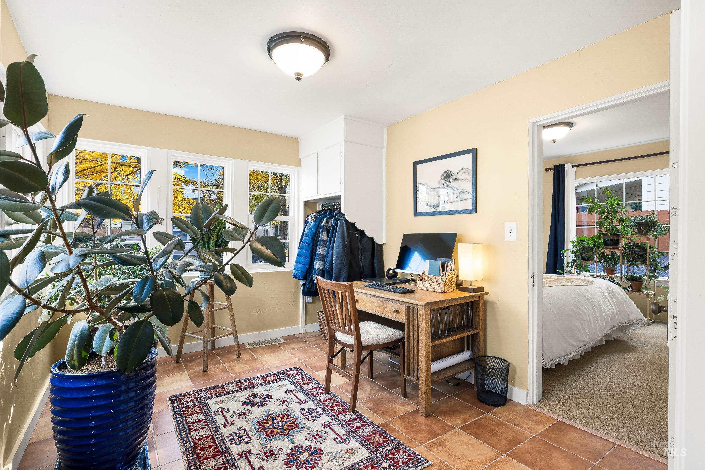 Office featuring light tile patterned flooring and baseboards