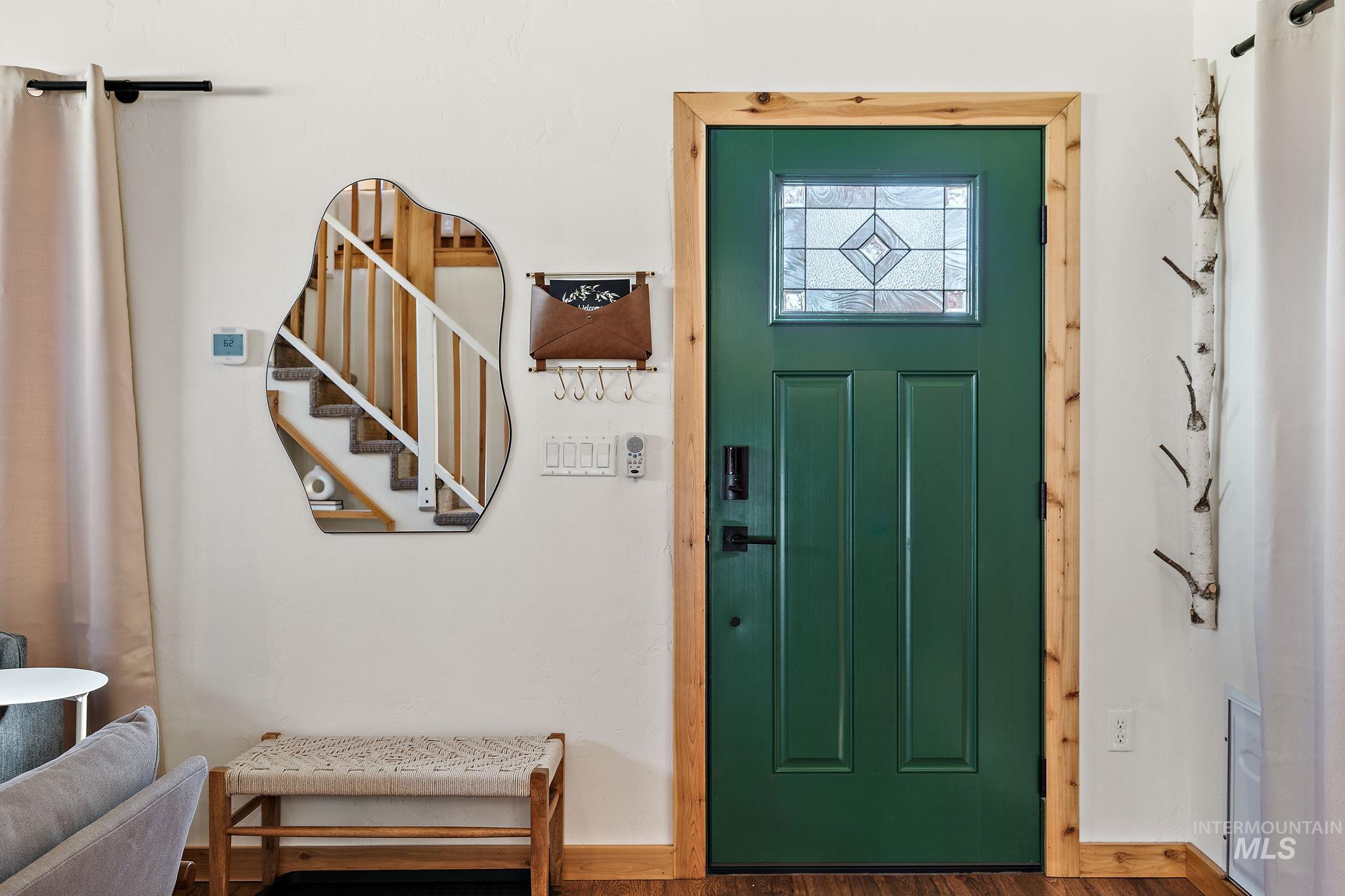 Foyer with stairway and wood finished floors