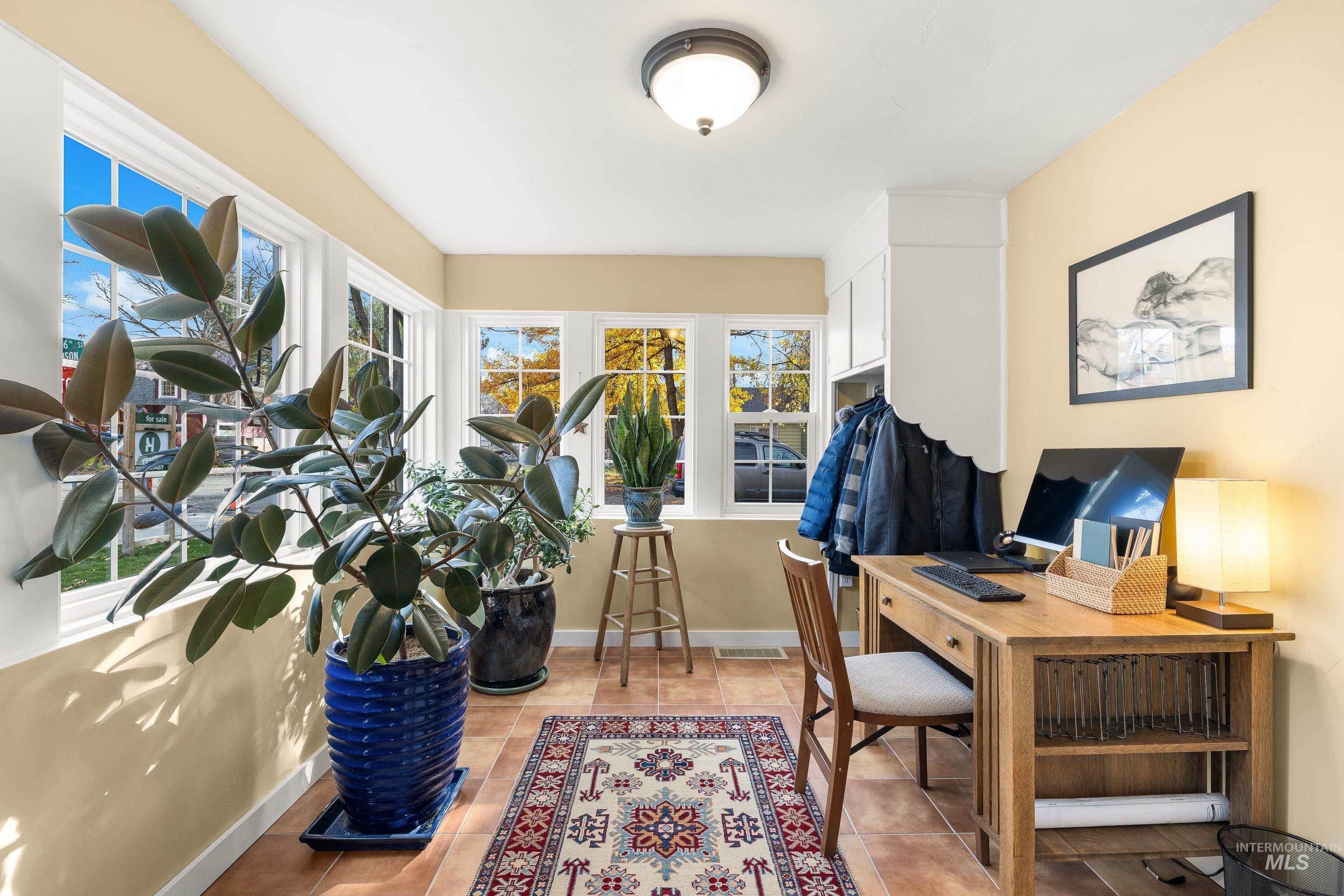 Office space featuring light tile patterned flooring and baseboards