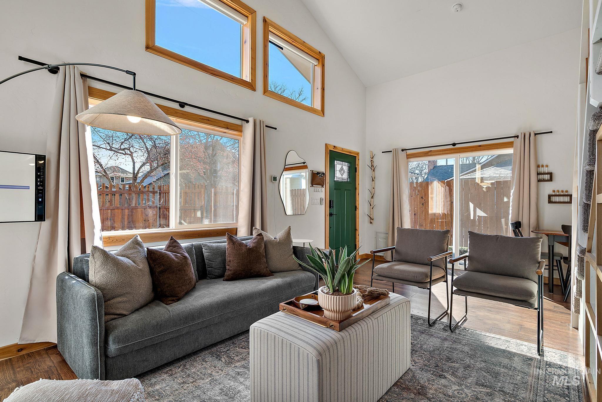 Living room featuring wood finished floors and high vaulted ceiling