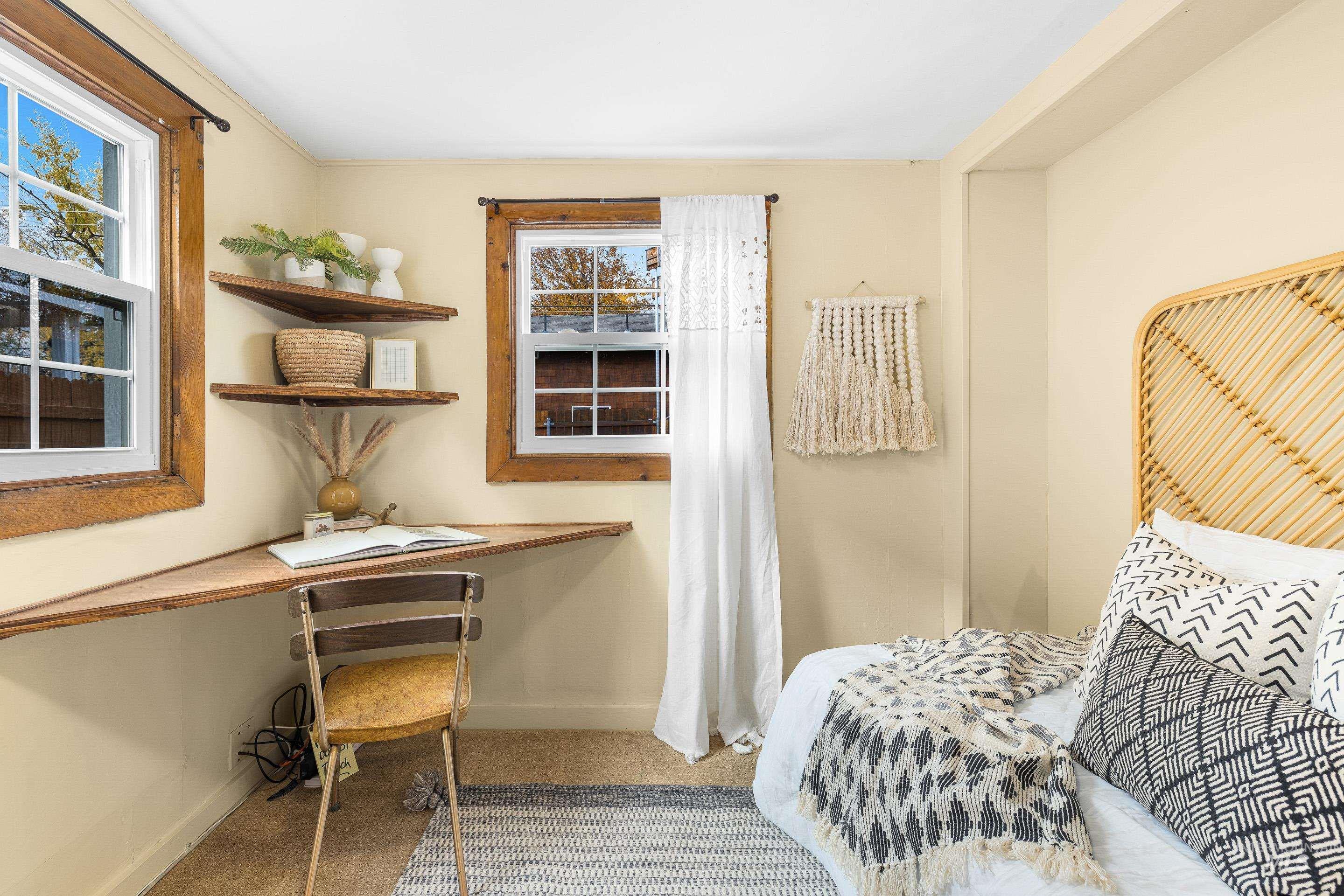 Bedroom with built in desk and light tile patterned floors