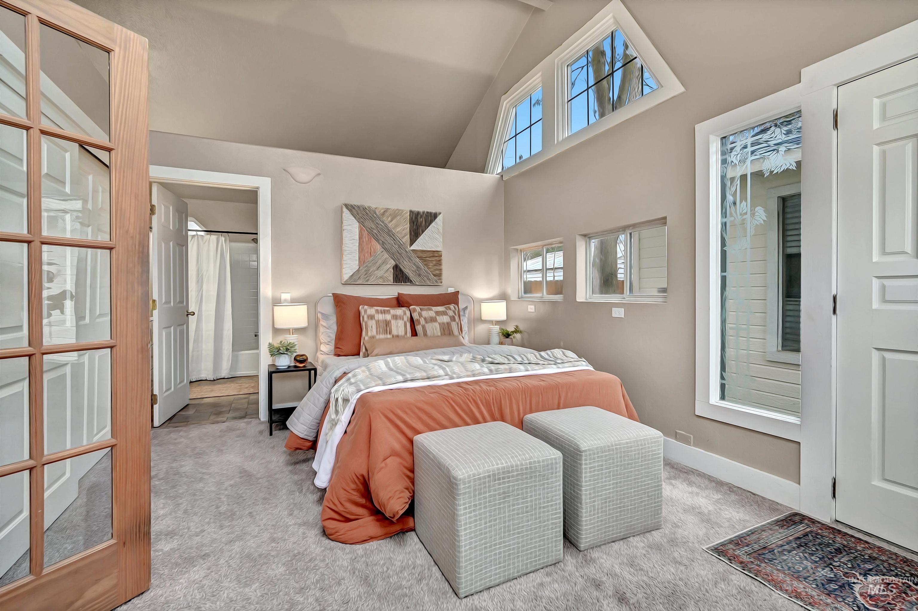 Inviting main-level ensuite with vaulted ceilings, plentiful windows, and its own private entrance for added flexibility.