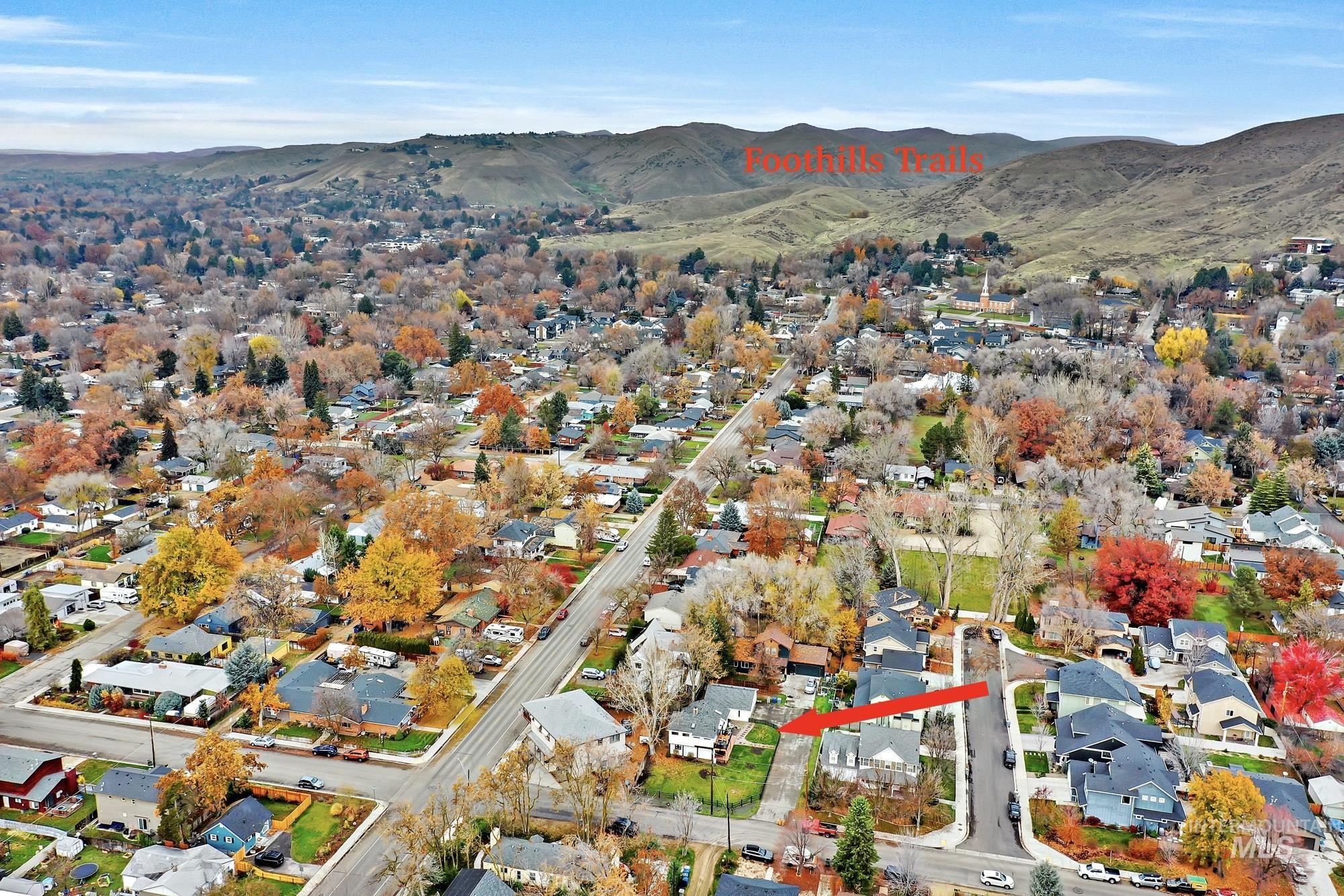 Aerial view of property location showing access to foothills trails in the background.