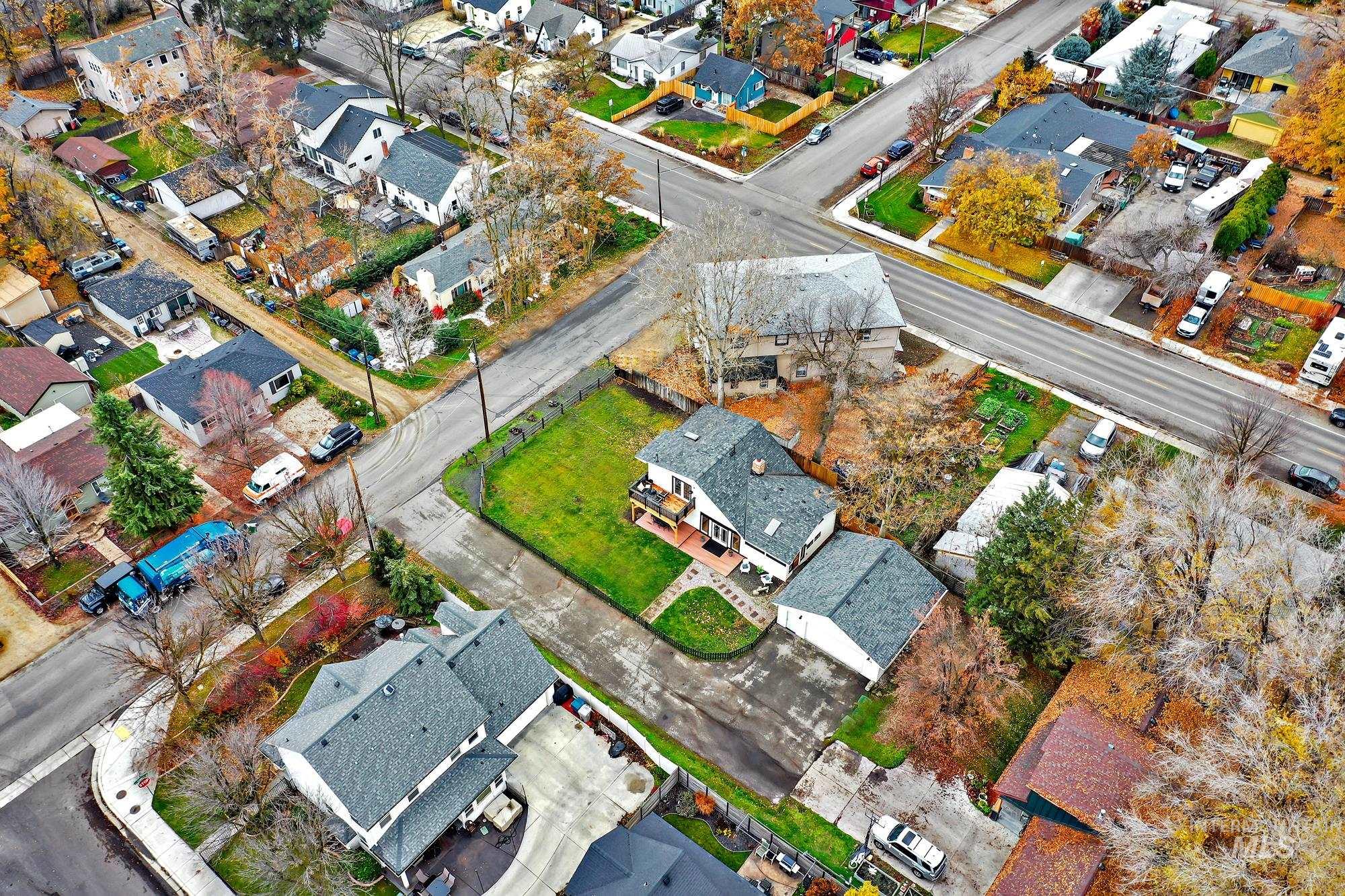 Aerial shot illustrating the home?s layout with the fenced yard, detached two-car garage, and easy access to outdoor spaces from both levels of the home.