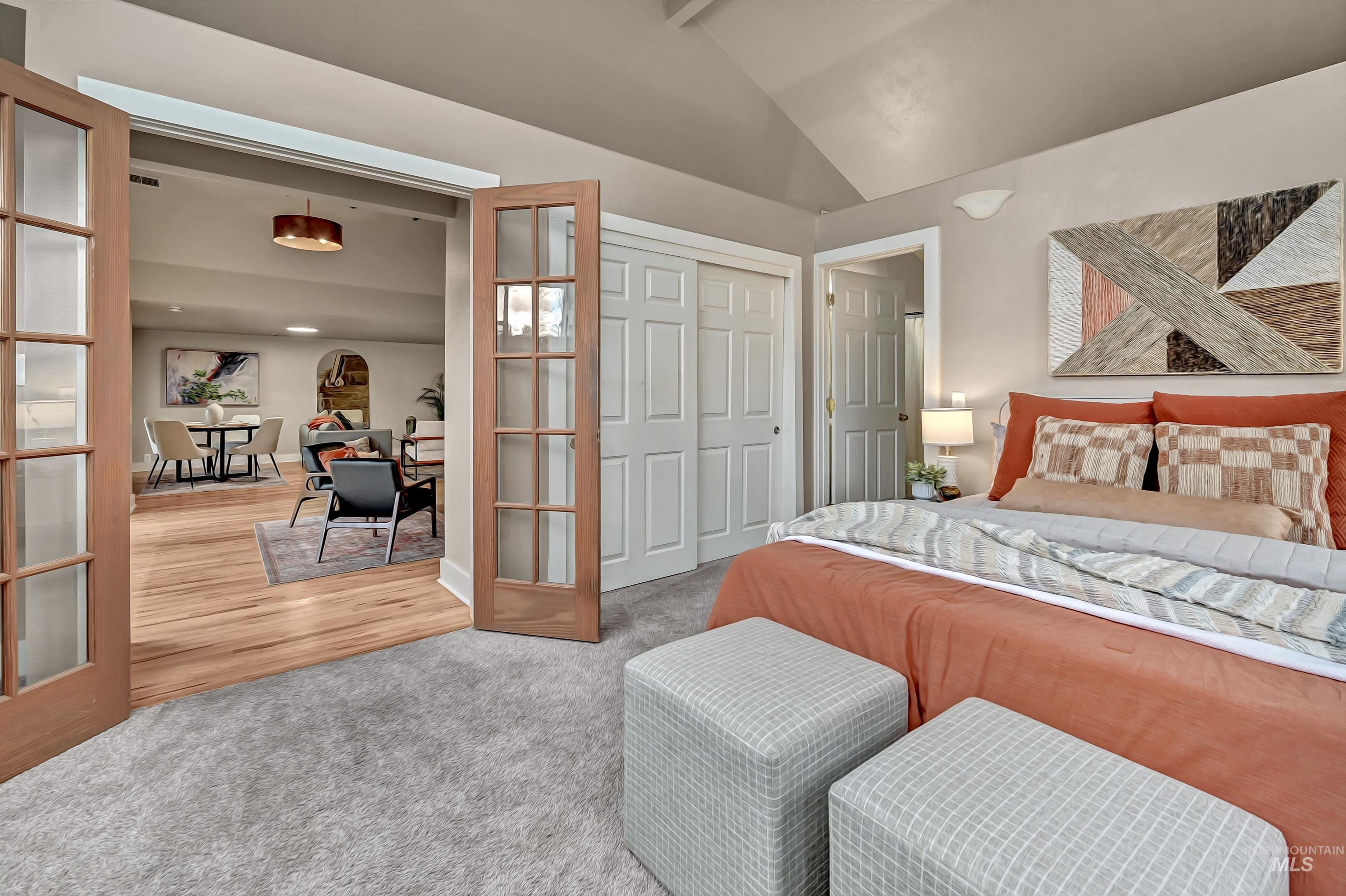 Main-level ensuite opens to the living and dining areas through French doors, creating a flexible and connected layout.