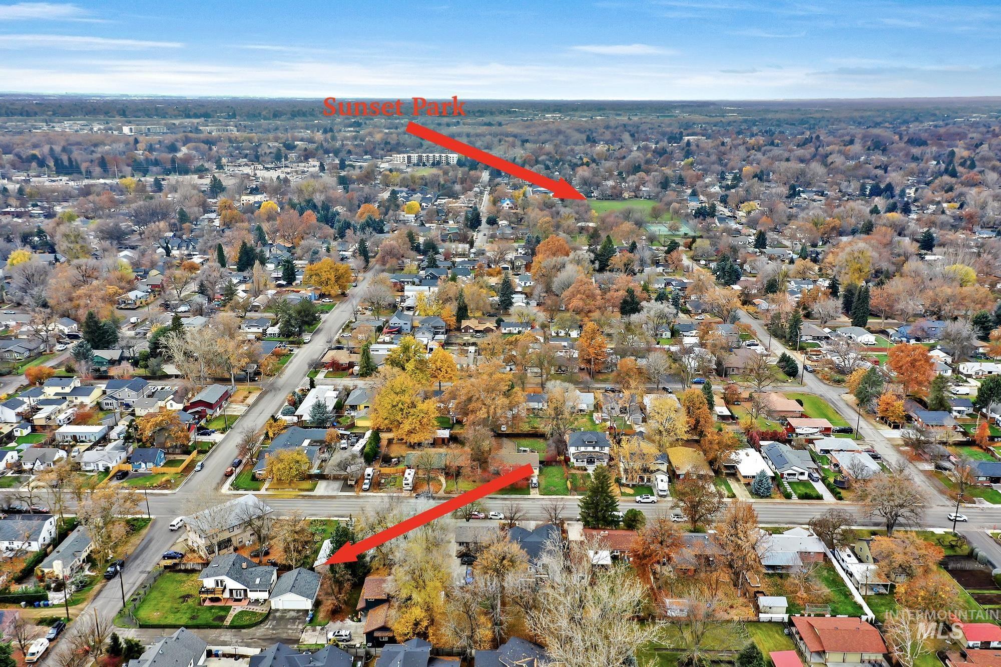 Aerial view showing quick access to Sunset Park with tennis courts, a covered playground, and large grassy areas.