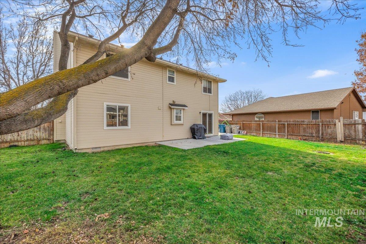 Rear view of house featuring a patio and a fenced backyard