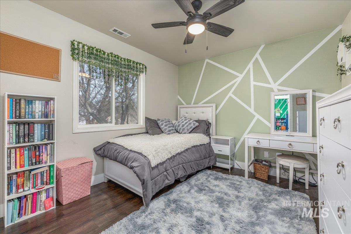 Bedroom featuring dark wood-style flooring and a ceiling fan