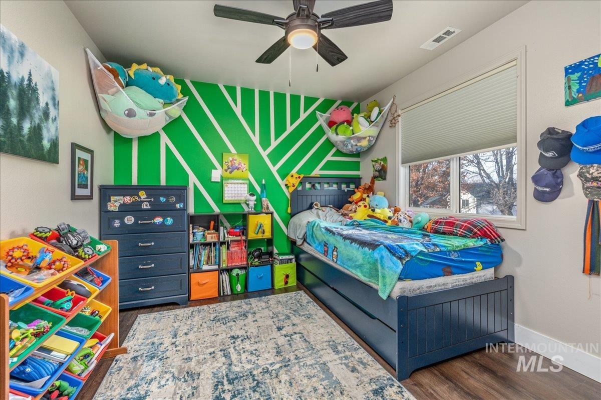 Bedroom featuring dark wood finished floors and ceiling fan