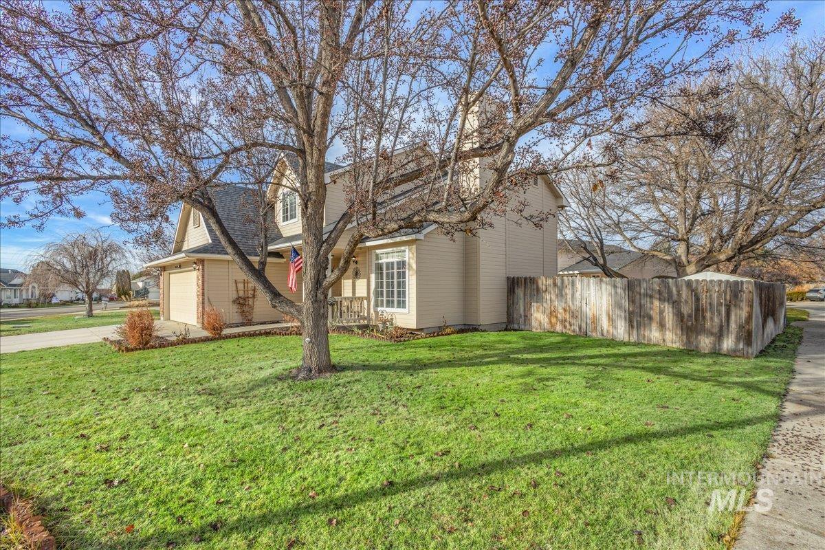 View of side of home featuring concrete driveway and a garage