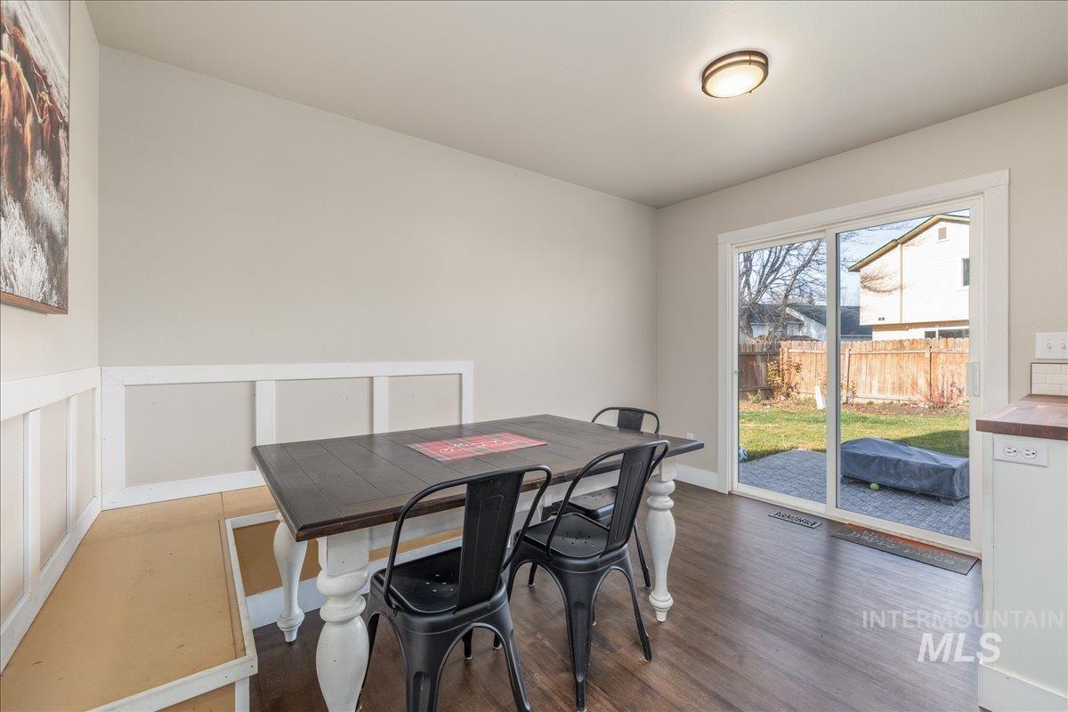 Dining space with wood finished floors and baseboards