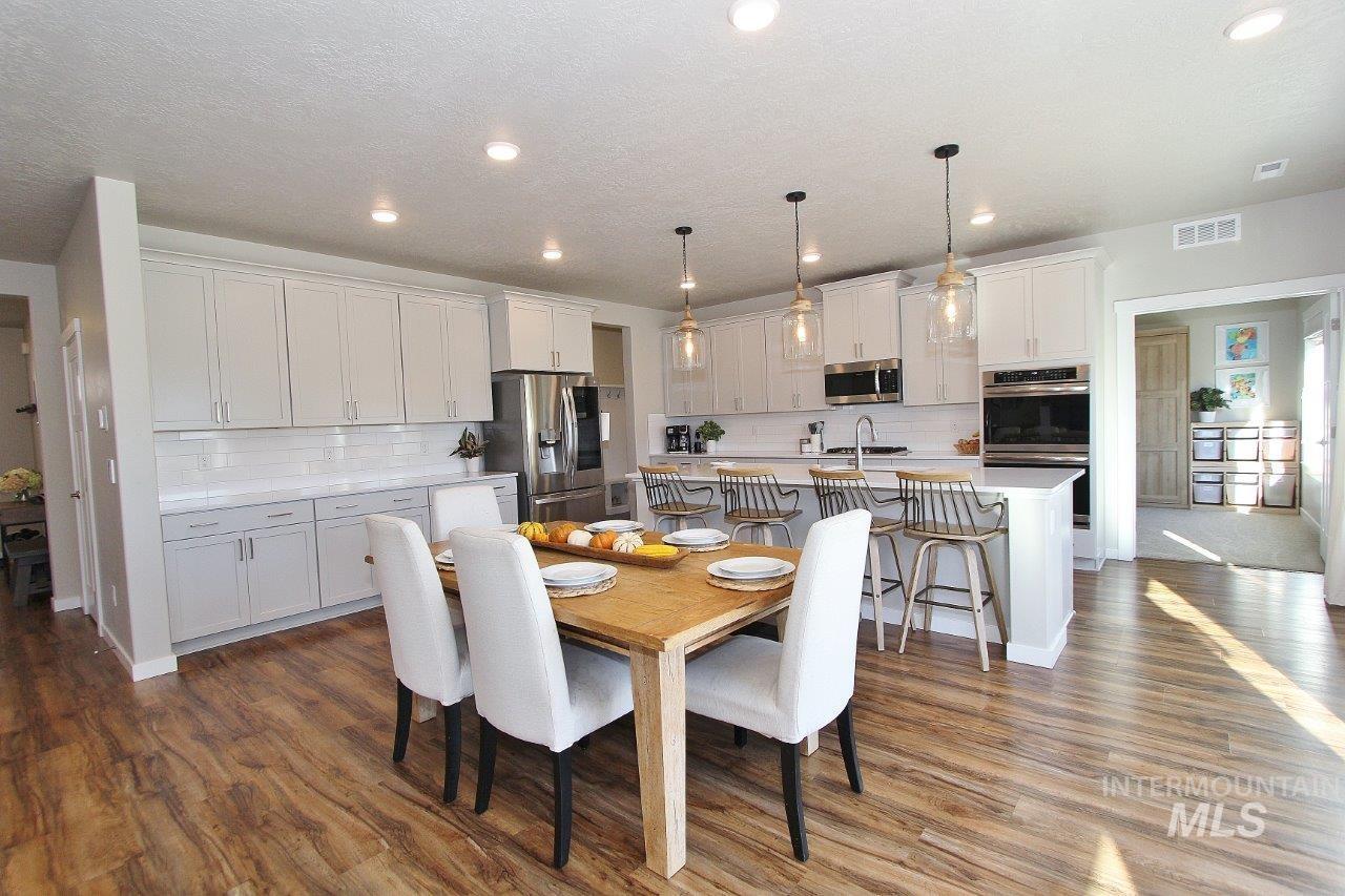Dining space with recessed lighting and dark wood finished floors