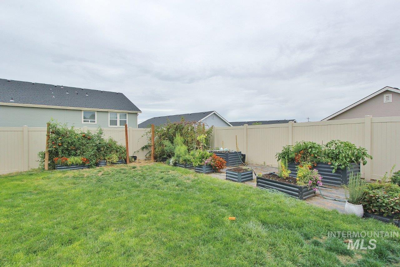 Fenced backyard with a garden