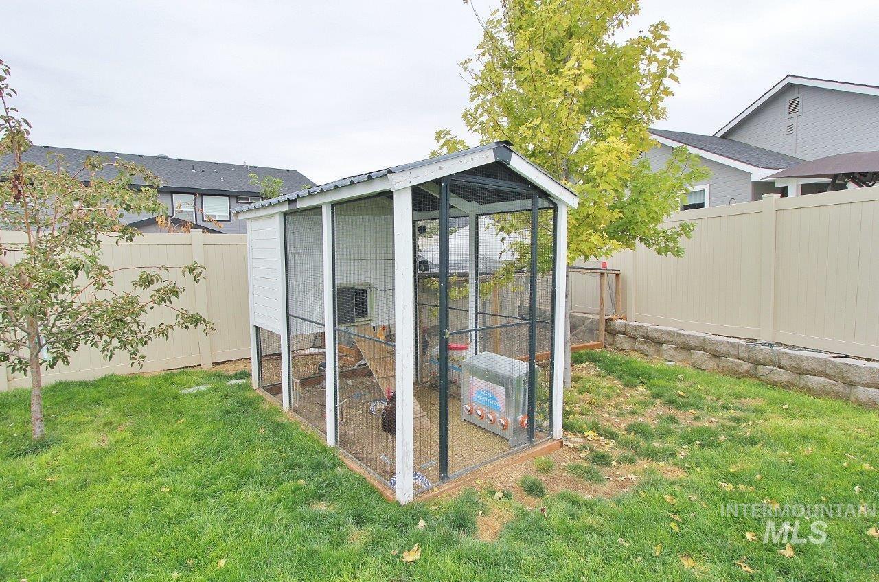 Fenced backyard with an outdoor structure and exterior structure