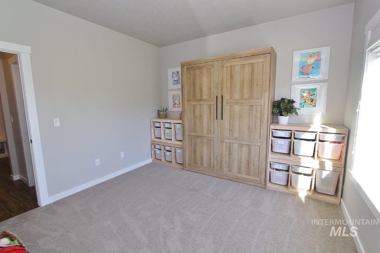 Flex room or 5th bedroom with baseboards and light carpet
