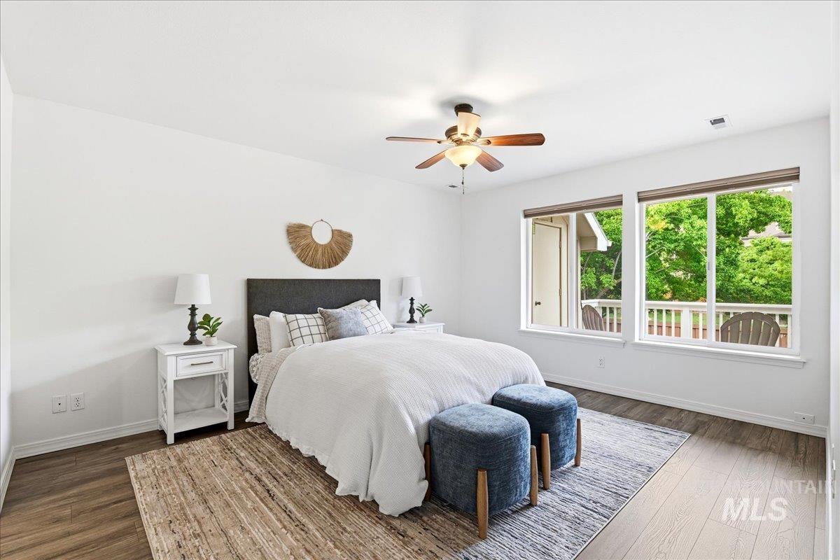 Bedroom featuring white walls and wood-finish flooring