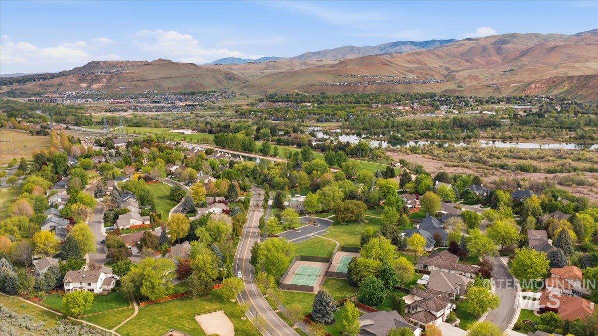 Aerial perspective showcasing a residential community with abundant mature trees and curving streets