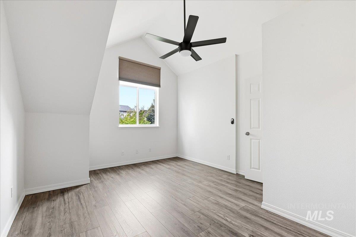 Room with vaulted ceilings and a ceiling fan