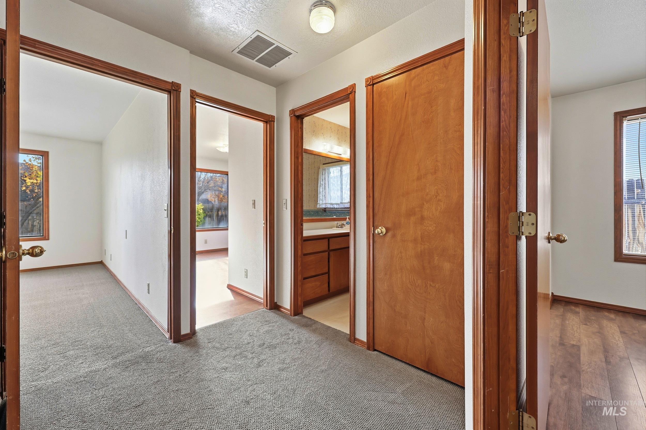 Hall with baseboards and carpet floors