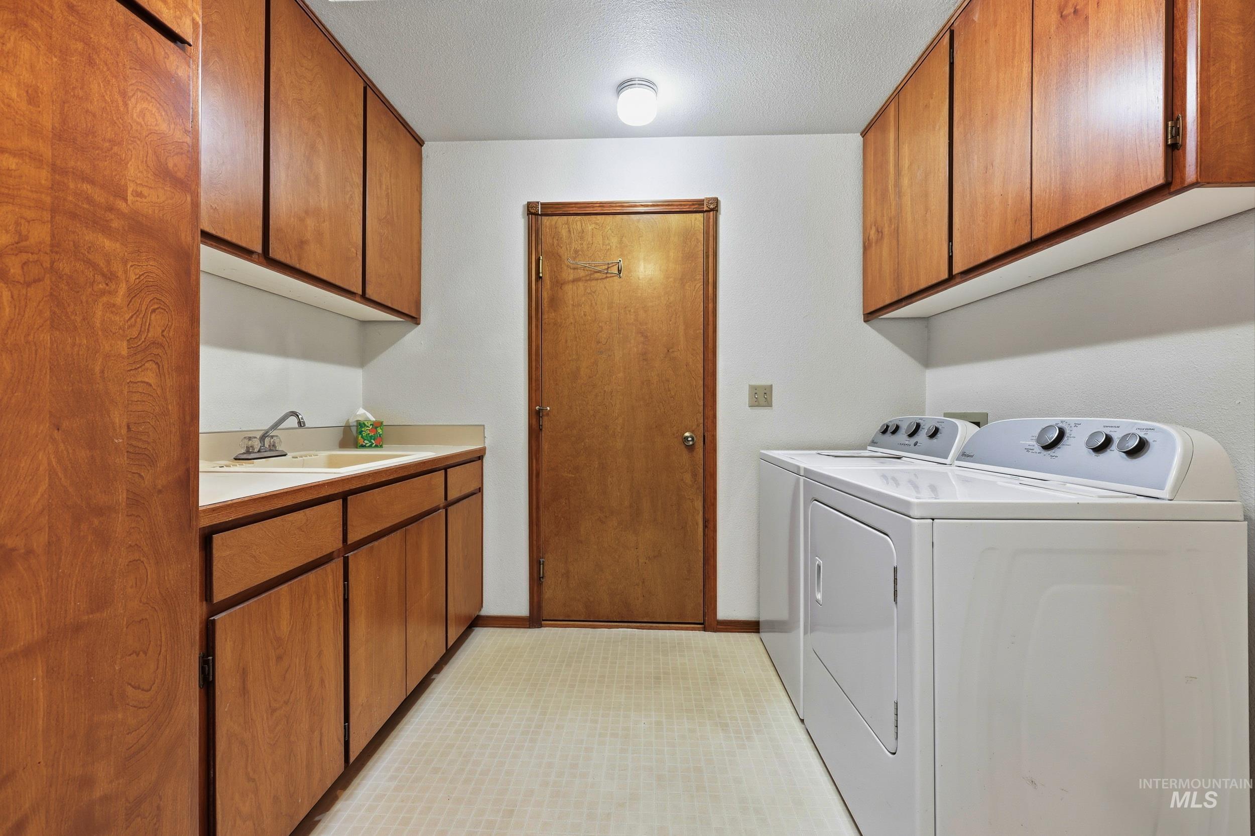 Laundry room with cabinet space and washer and dryer