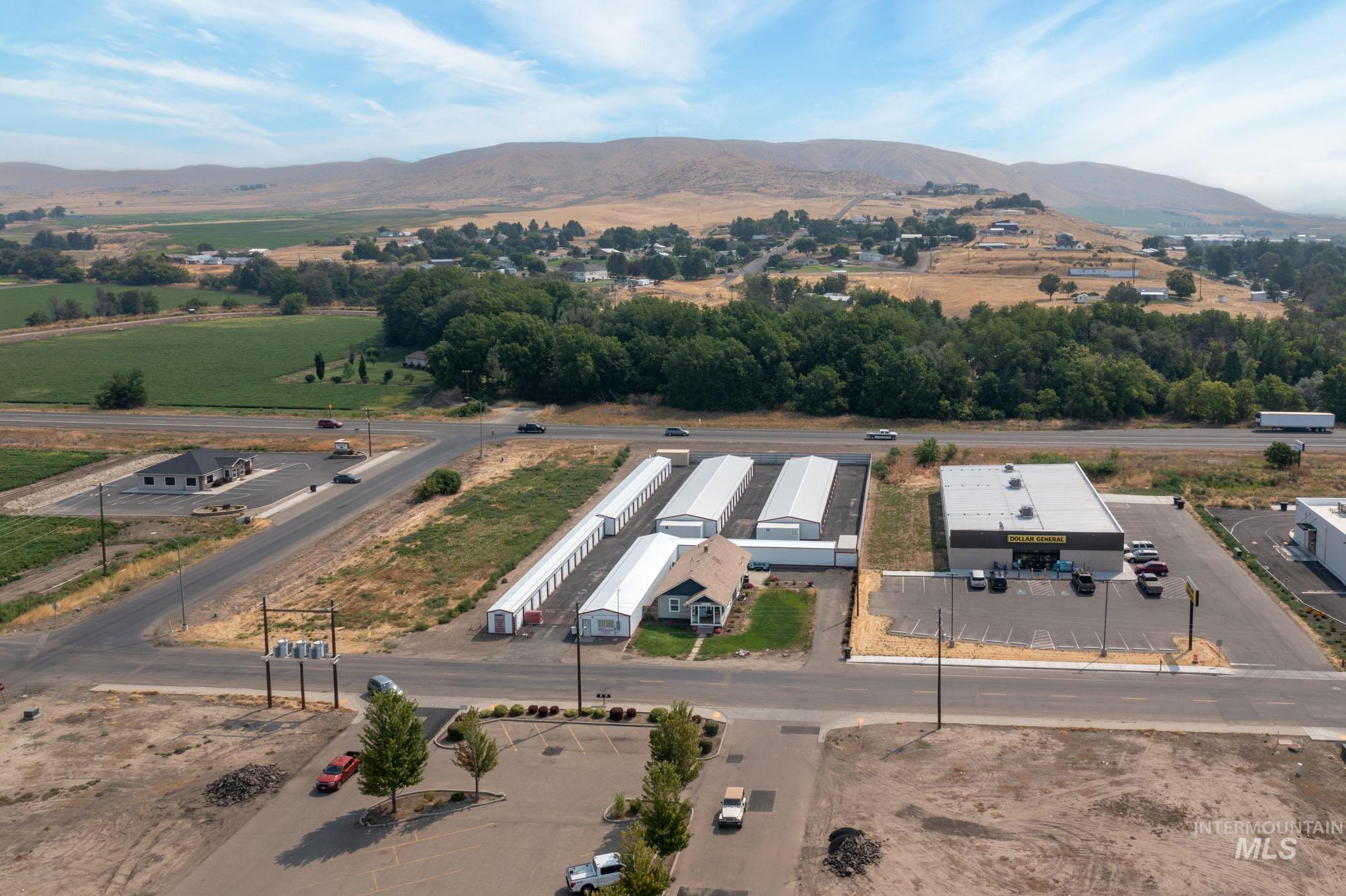 Aerial perspective showcasing multiple commercial structures and expansive open land
