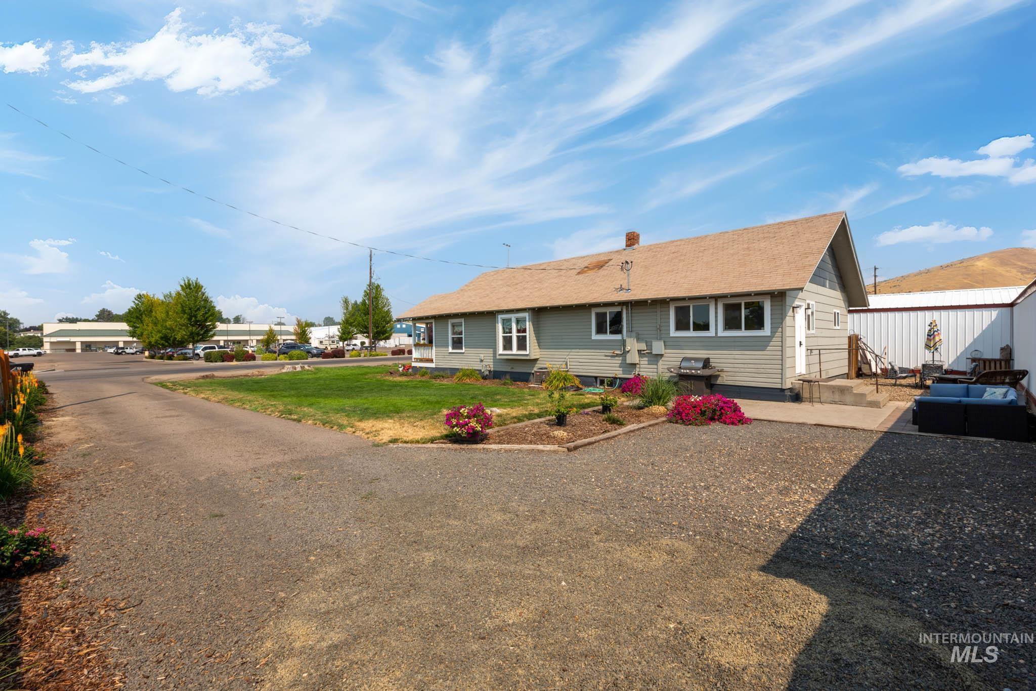 Ranch-style residence featuring light green siding and white trim