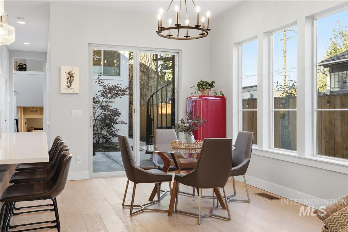 Dining room featuring light wood-type flooring and a chandelier