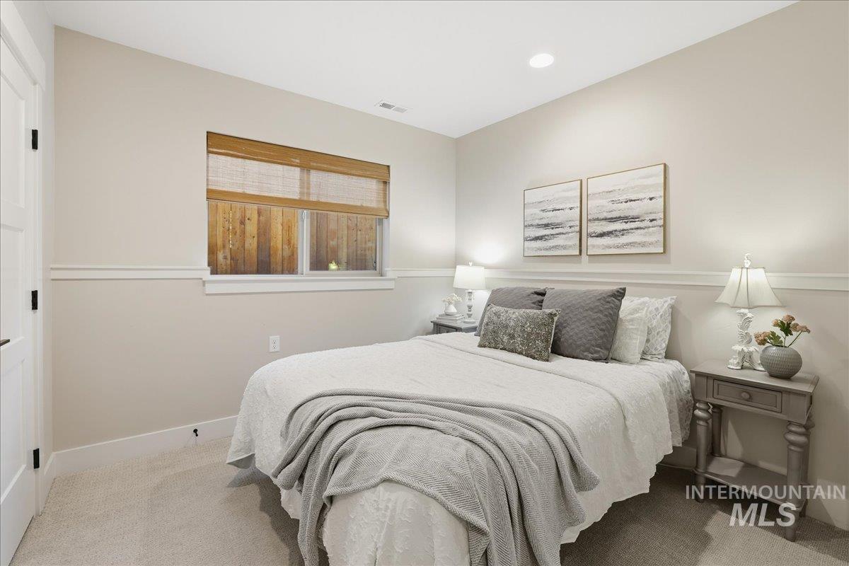Carpeted bedroom with baseboards and recessed lighting