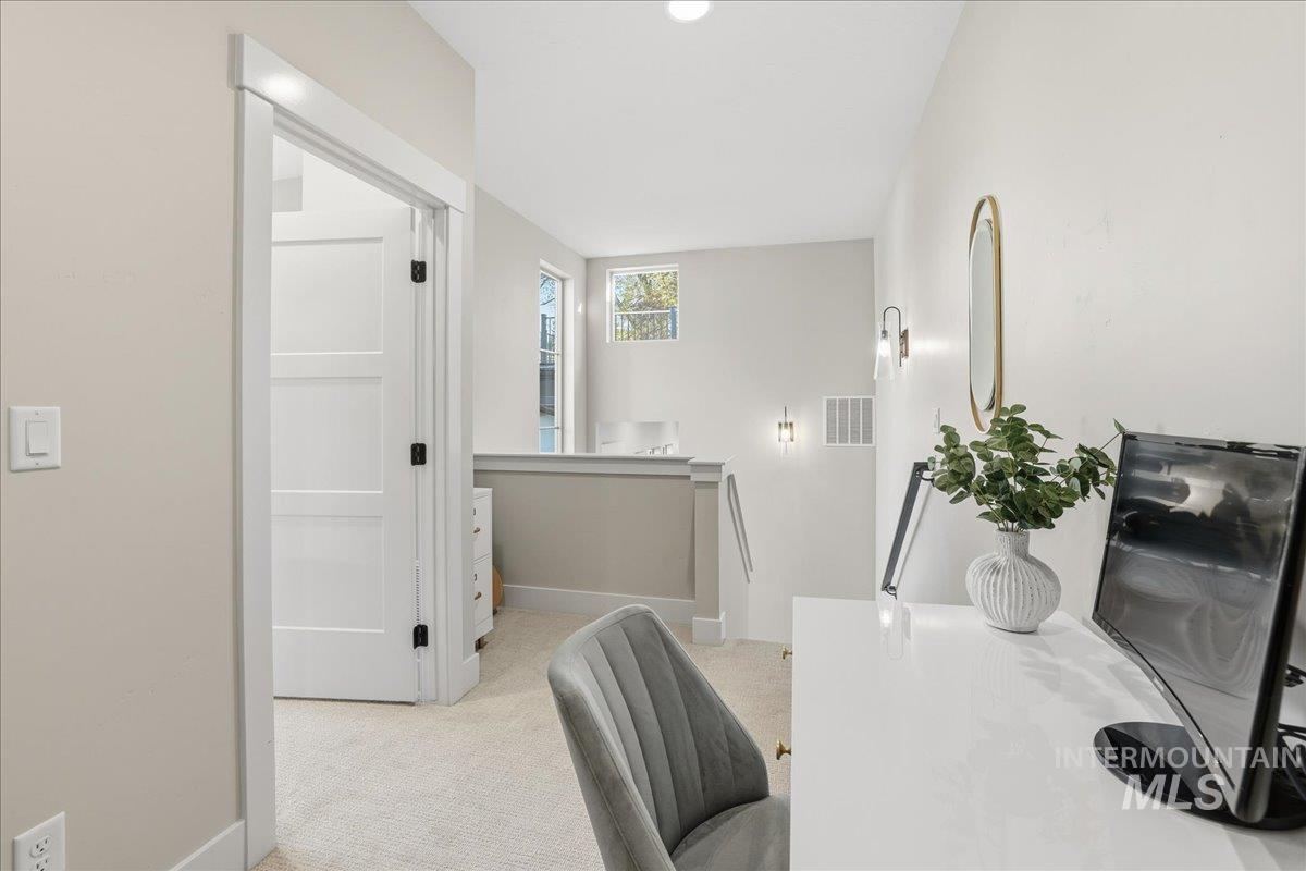 Dining space with light carpet and recessed lighting