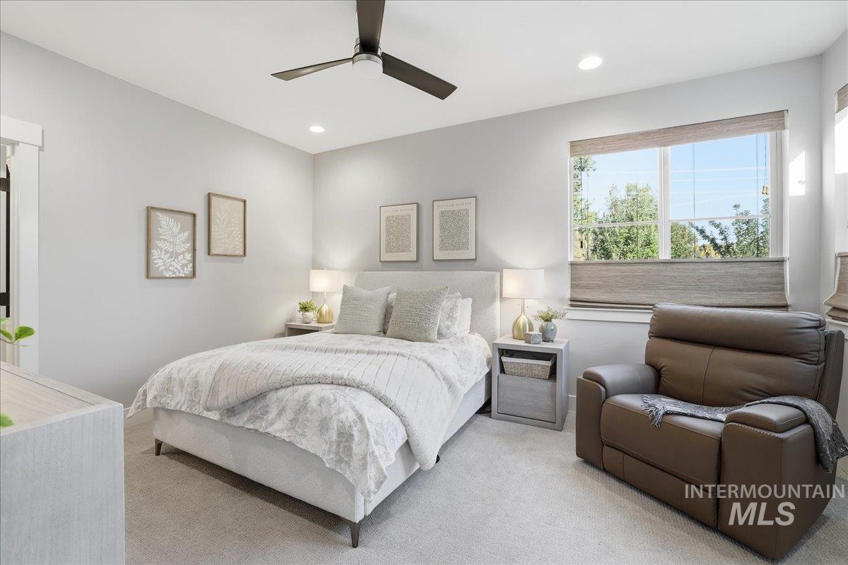 Carpeted bedroom with recessed lighting and a ceiling fan
