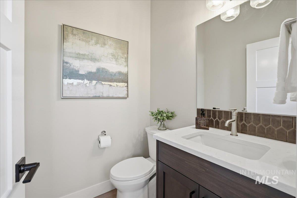 Bathroom featuring vanity and tasteful backsplash