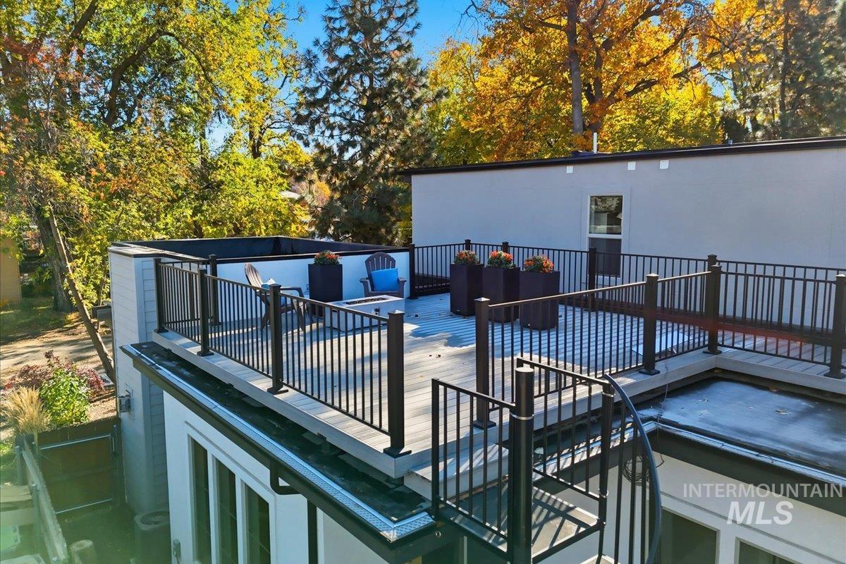 Wooden deck with view of wooded area
