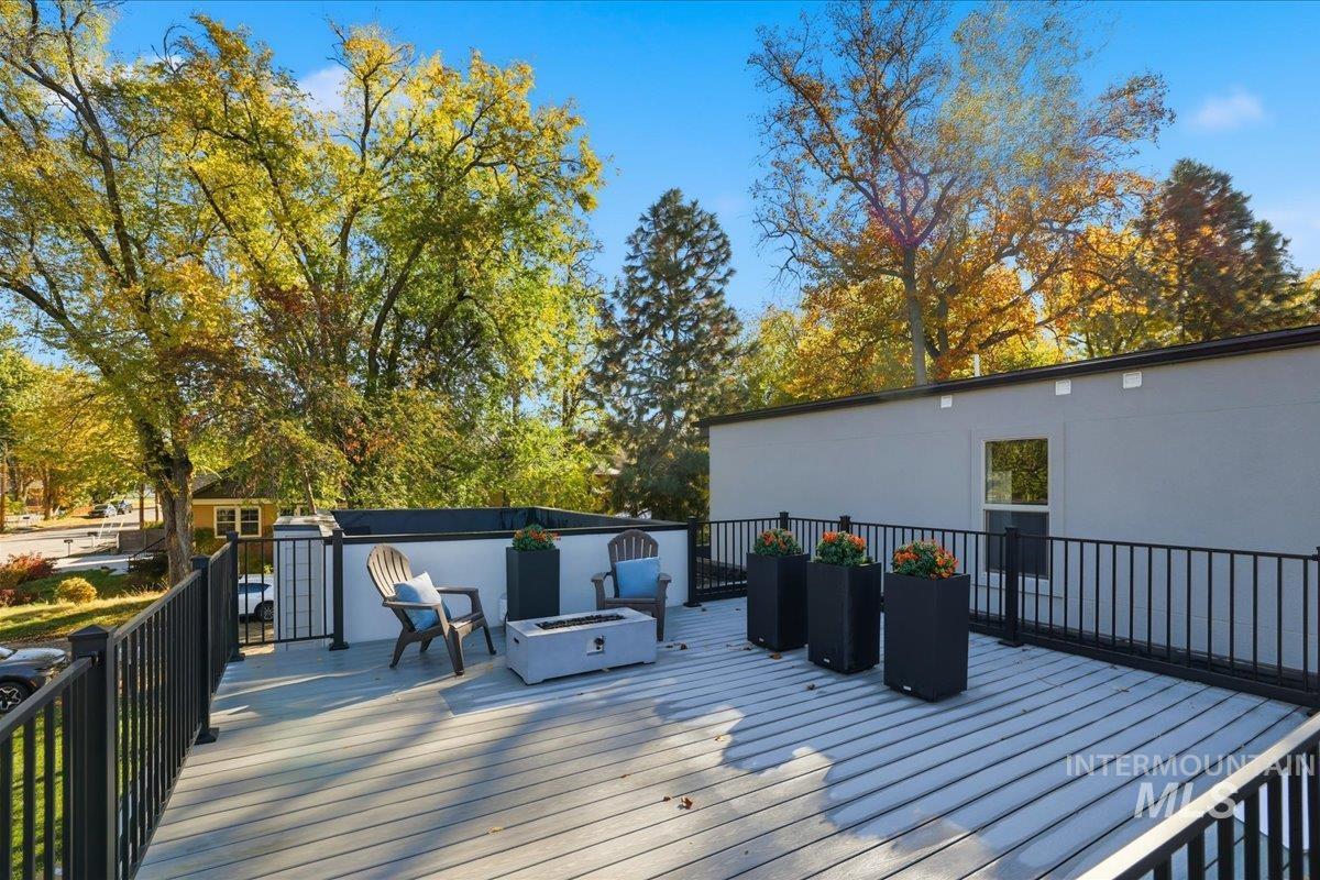 Wooden terrace featuring a fire pit