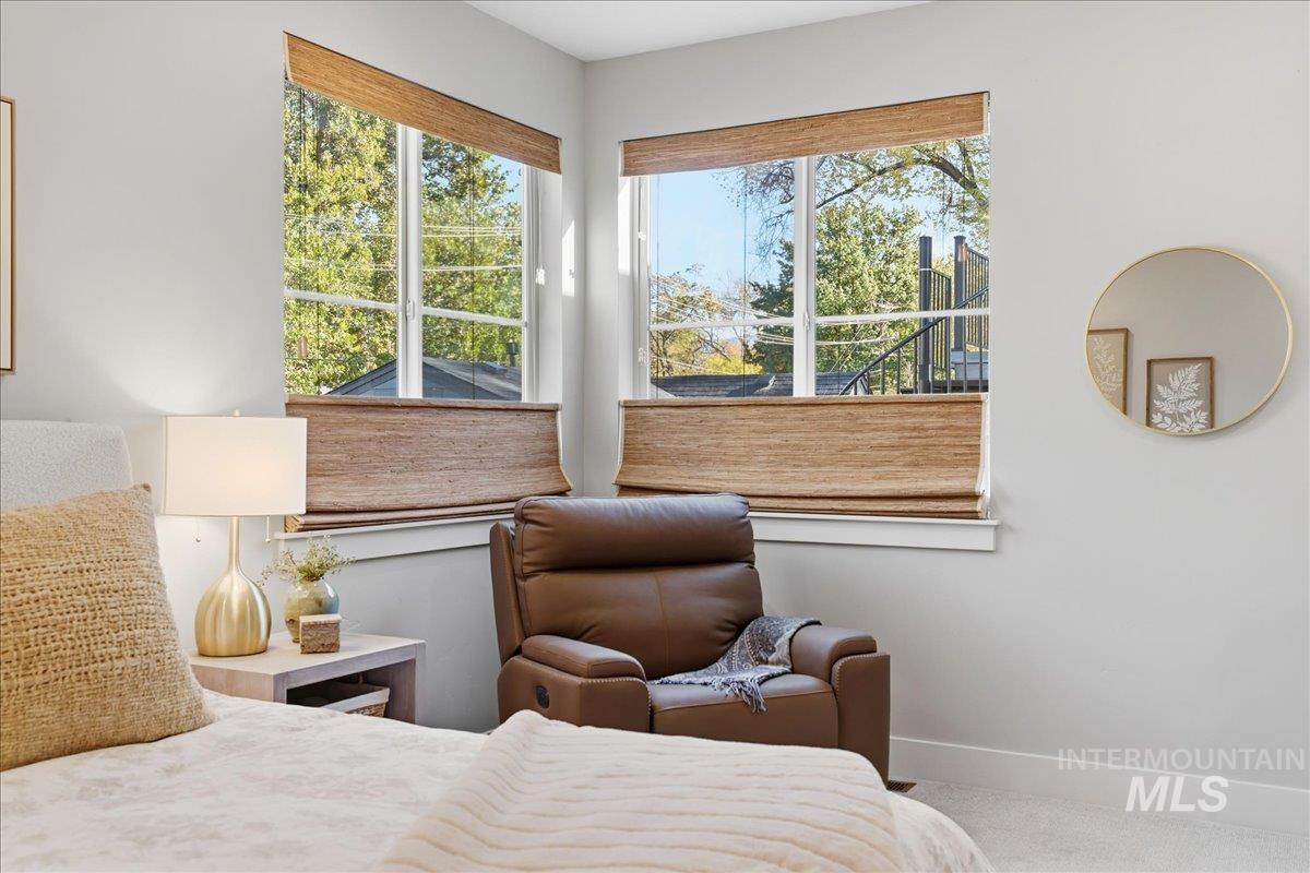 Carpeted bedroom featuring baseboards