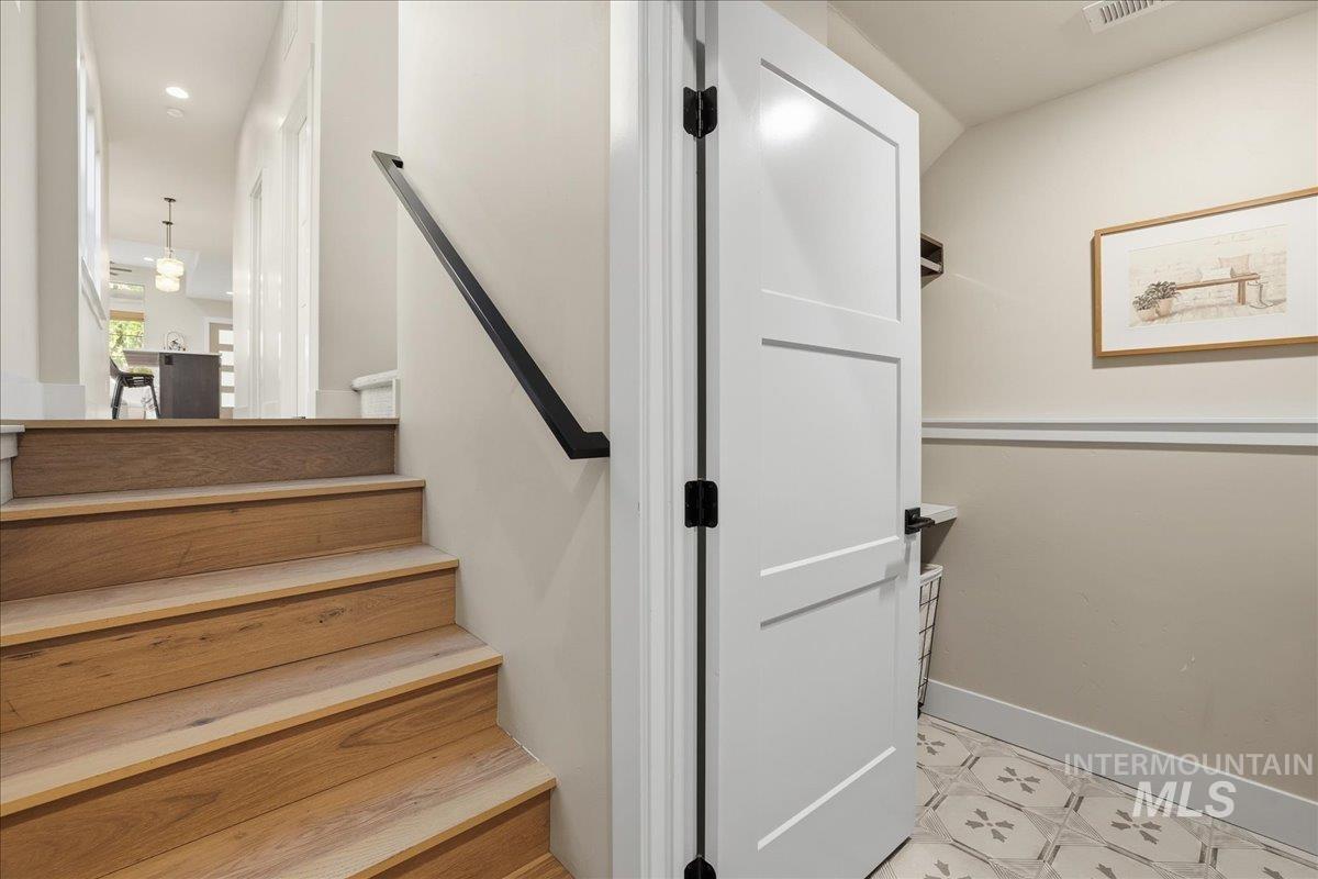 Stairway featuring recessed lighting and tile patterned flooring
