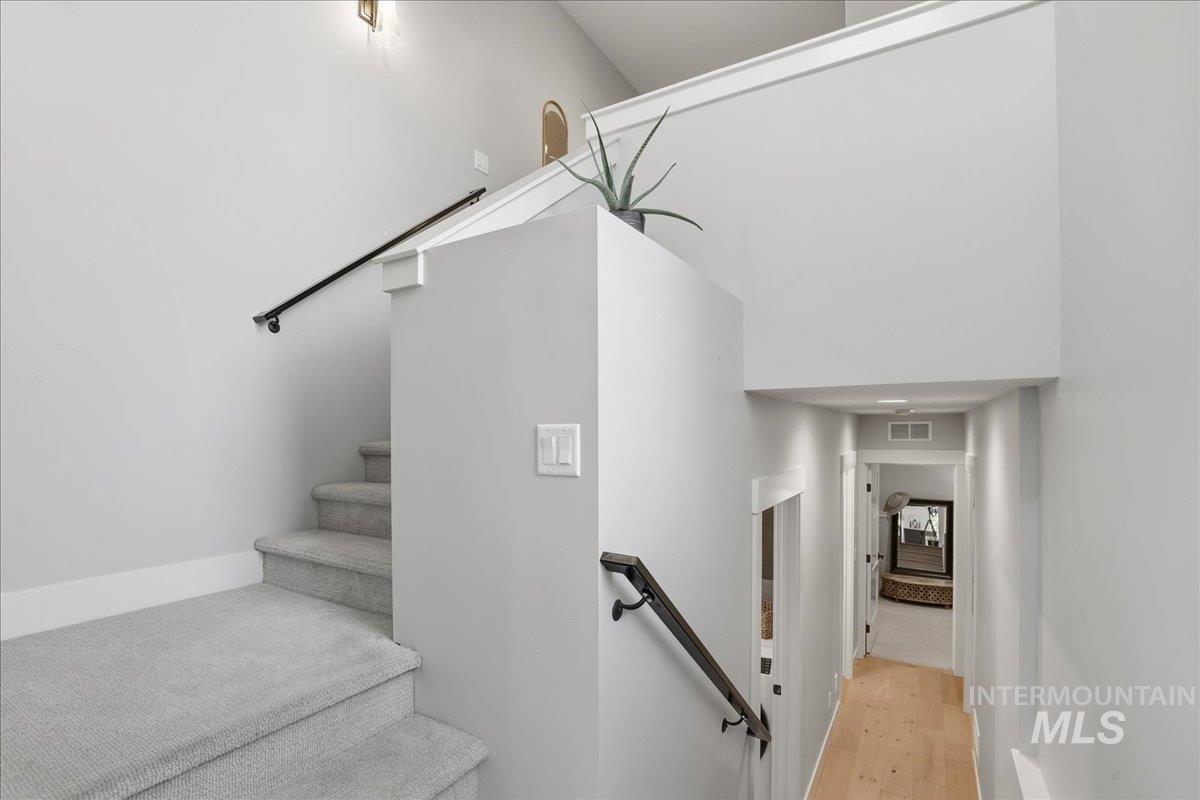 Stairway featuring baseboards and wood finished floors
