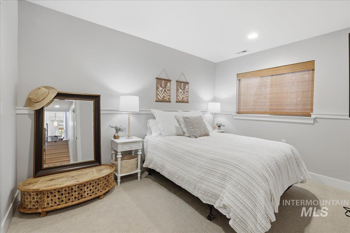Carpeted bedroom with baseboards and recessed lighting