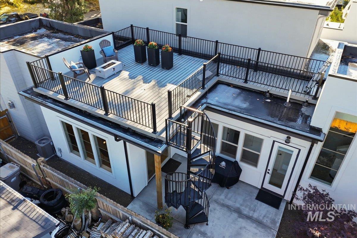 View of property with stairway and a fire pit