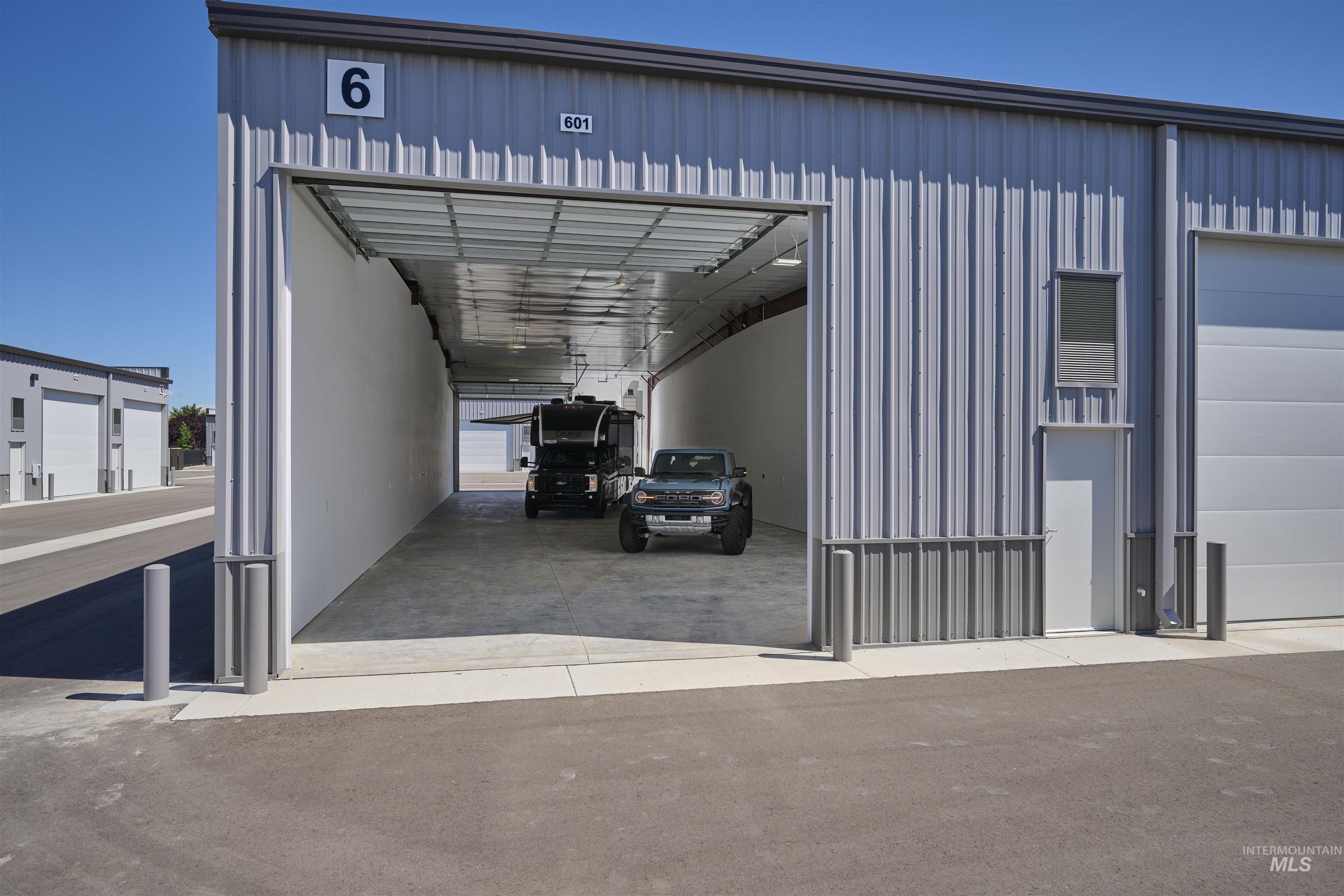 View of parking with a garage