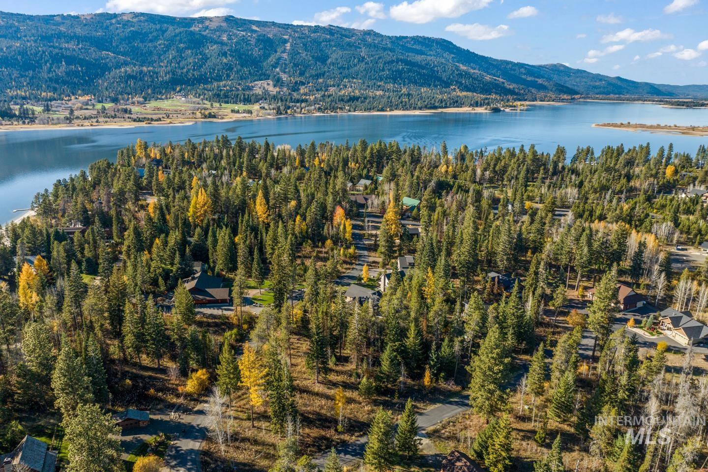 Aerial view of property's location featuring a water and mountain view
