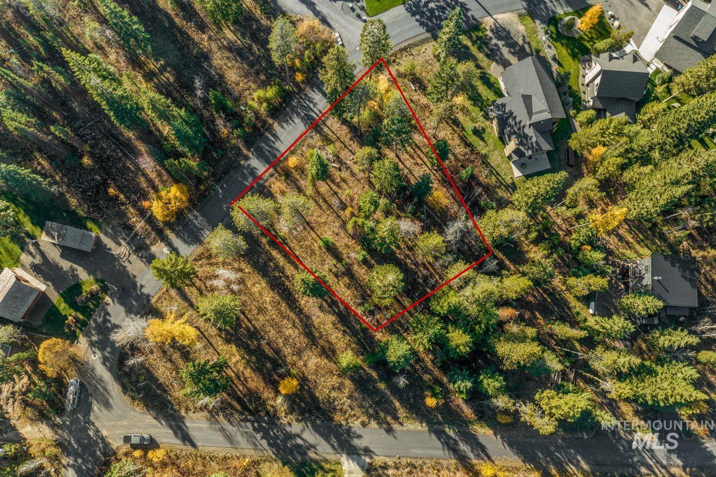 Aerial view of property and surrounding area with property parcel outlined