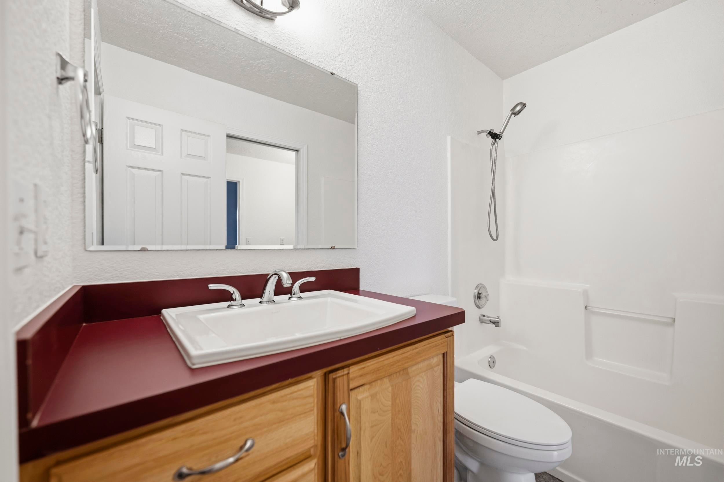 Full bathroom featuring vanity and shower / tub combination