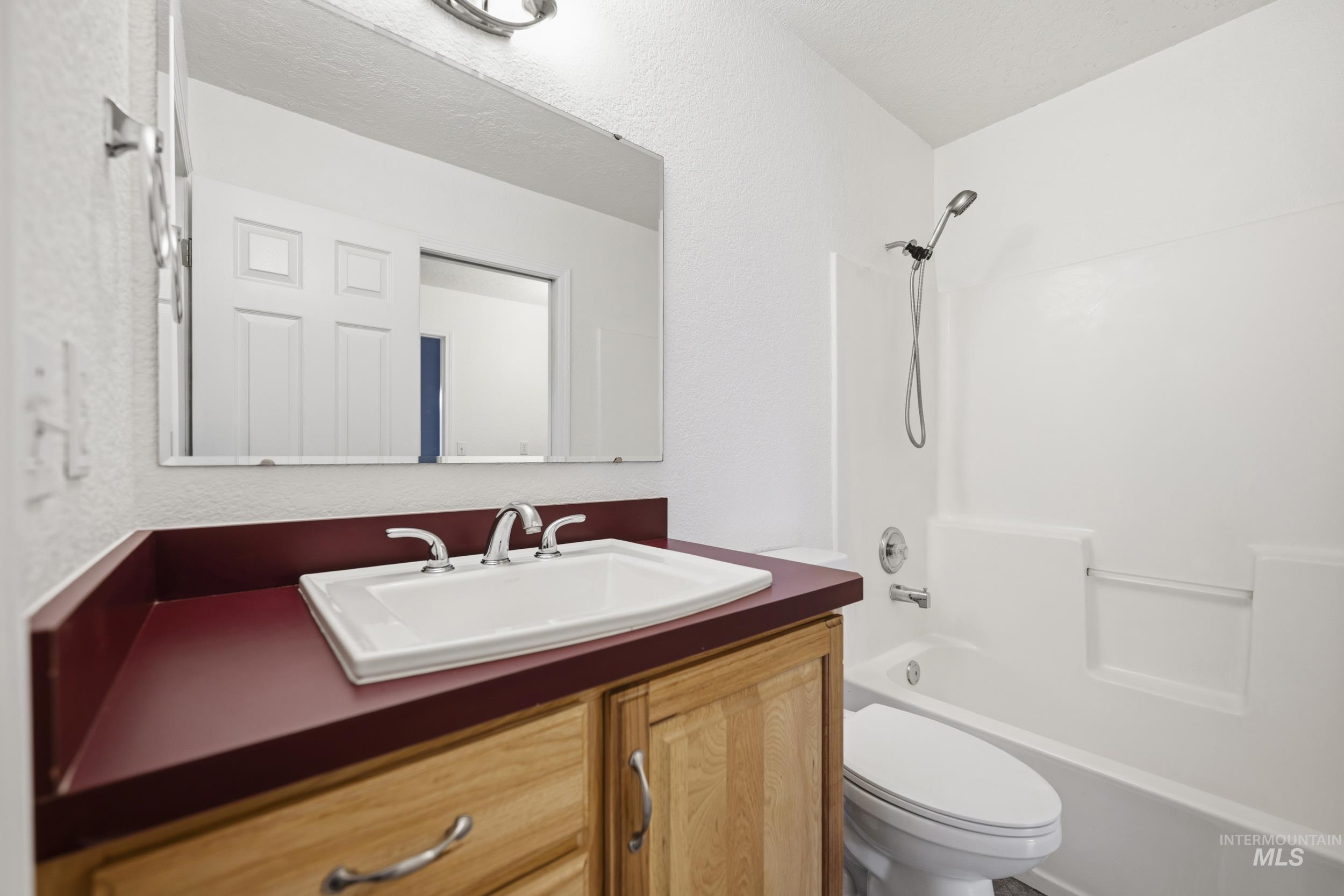 Full bathroom featuring vanity and shower / tub combination