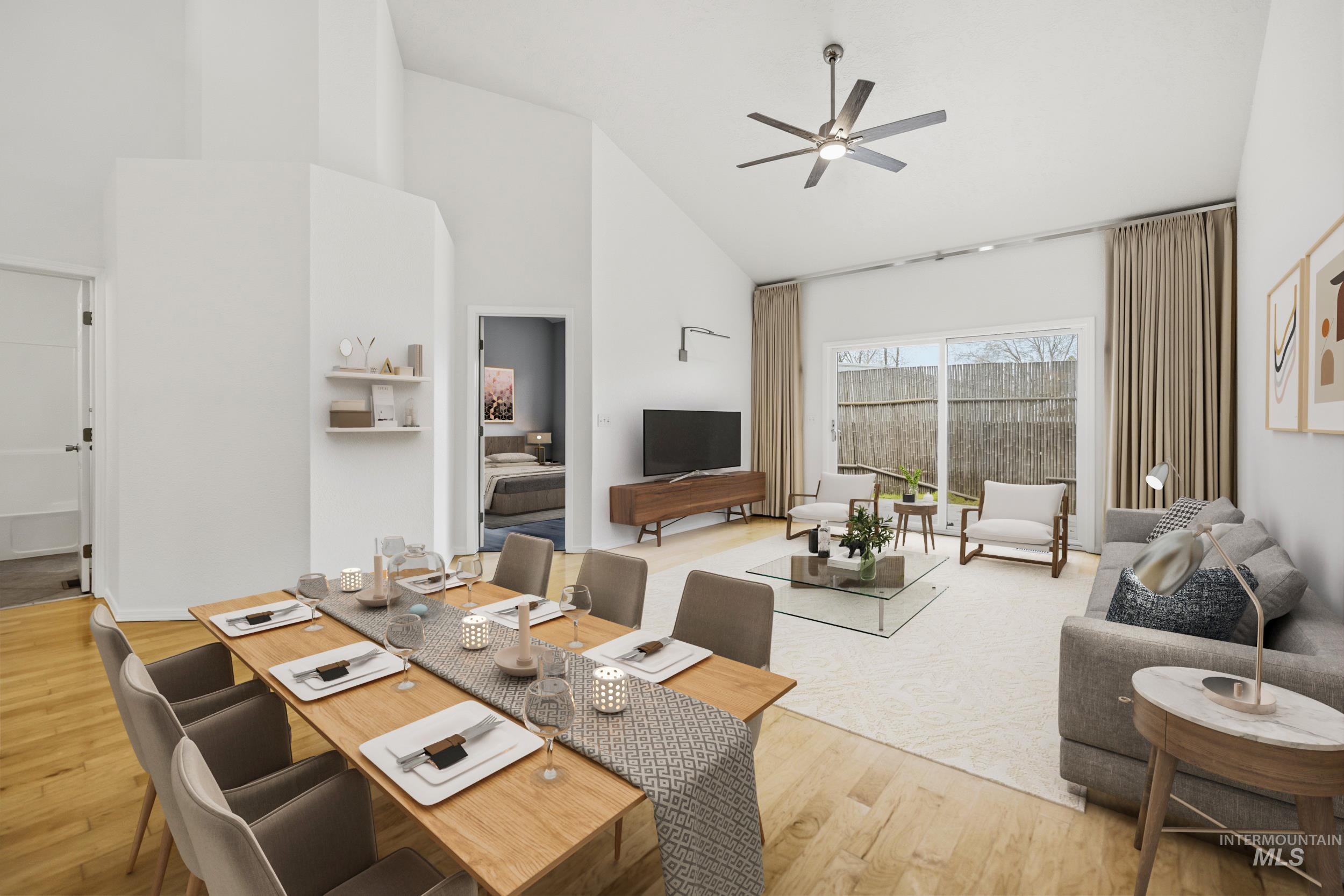 Dining area featuring light wood-style flooring, ceiling fan, and vaulted ceiling