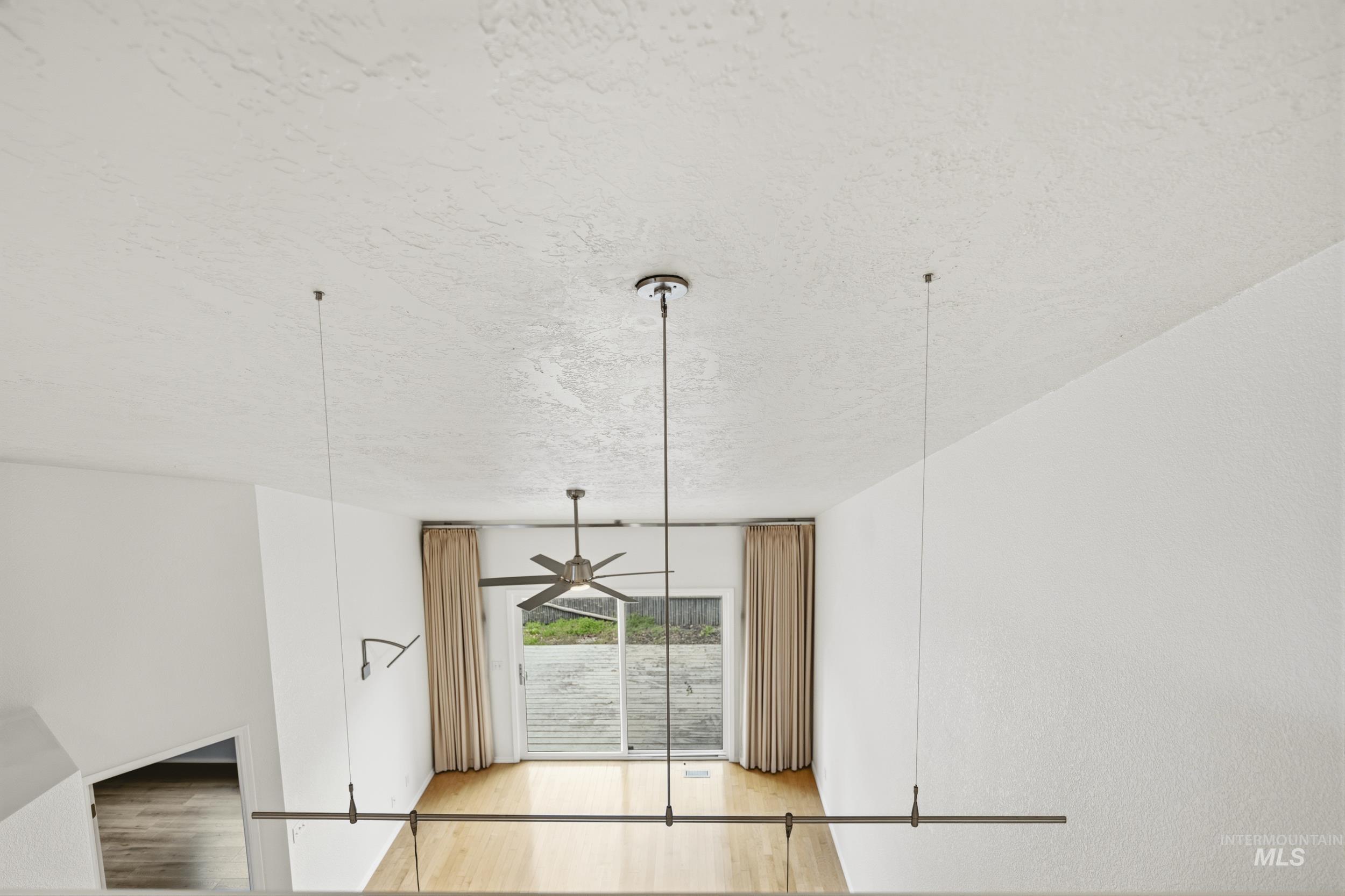 Detailed view of a textured ceiling and wood finished floors