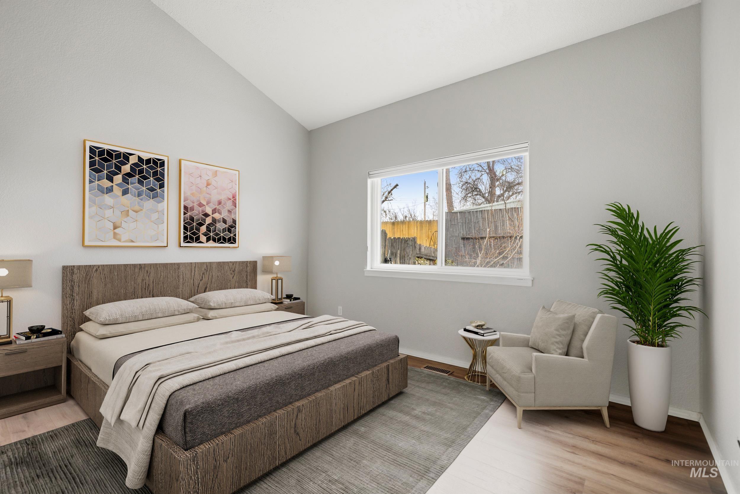 Bedroom featuring vaulted ceiling and wood finished floors