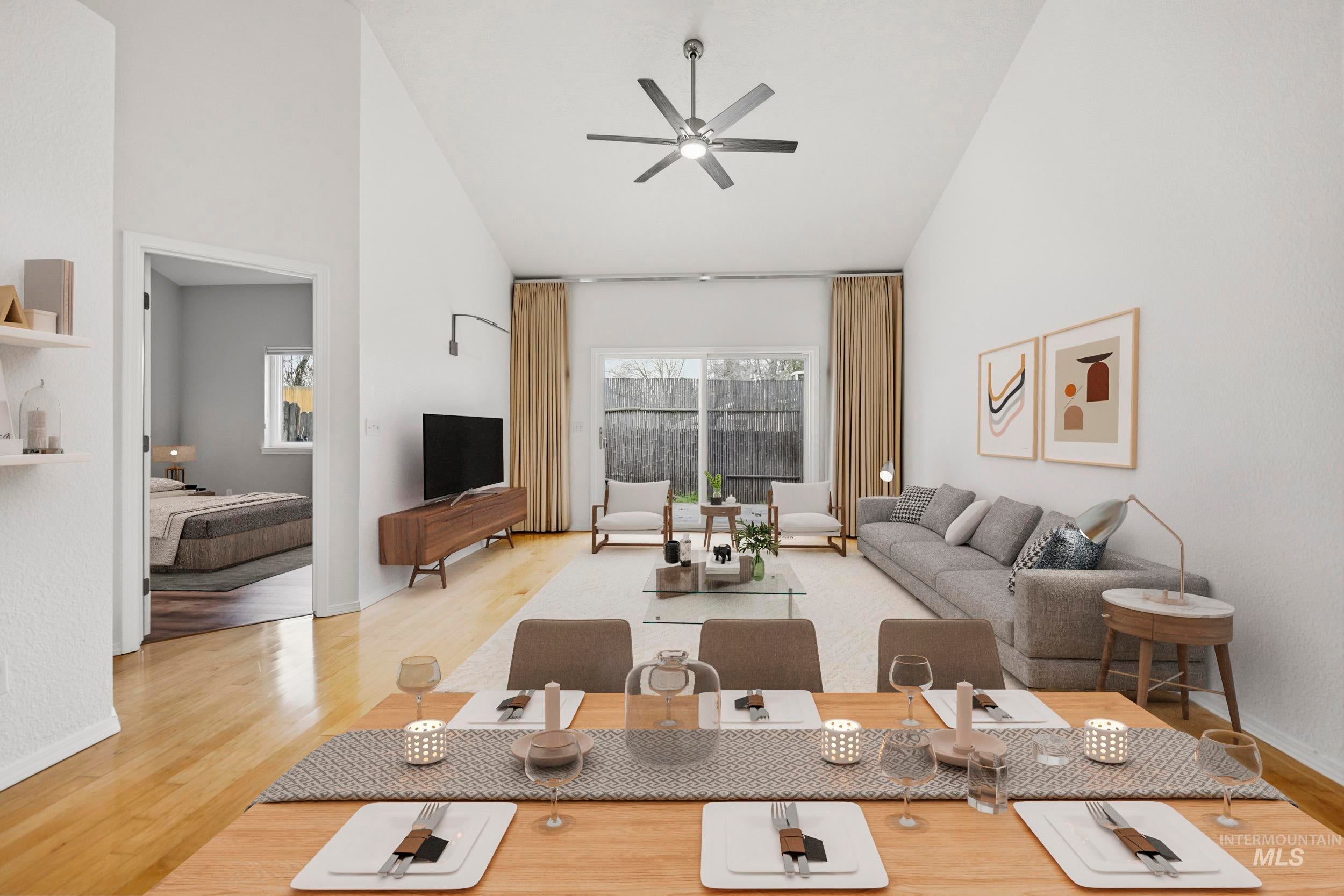 Living room featuring lofted ceiling, light wood-type flooring, and ceiling fan