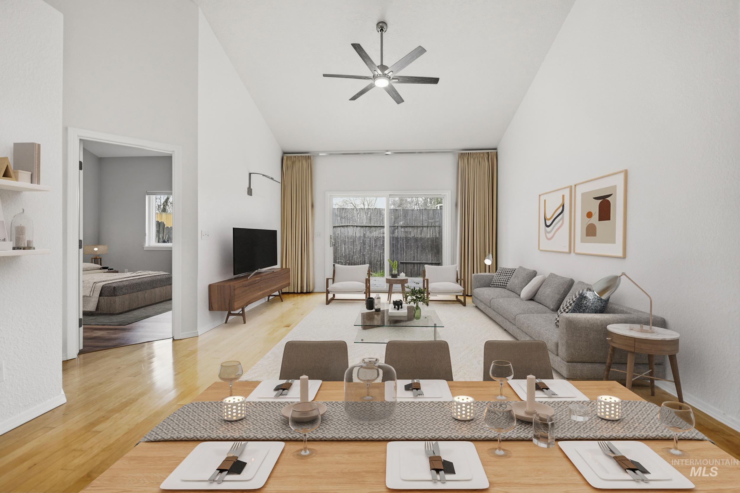 Living room featuring lofted ceiling, light wood-type flooring, and ceiling fan