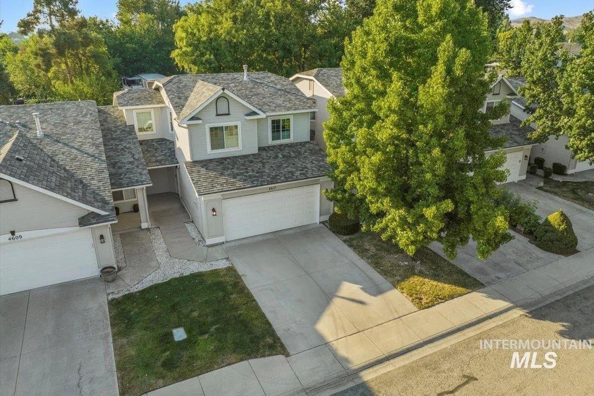 View of front facade with driveway and an attached garage
