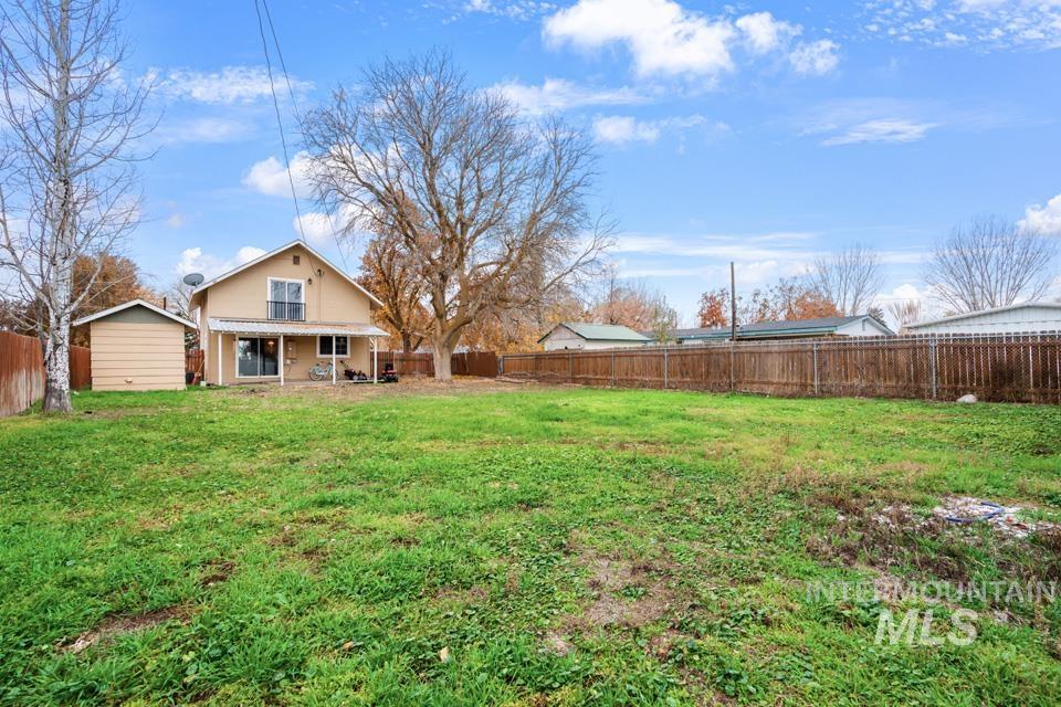 Fenced backyard featuring a patio